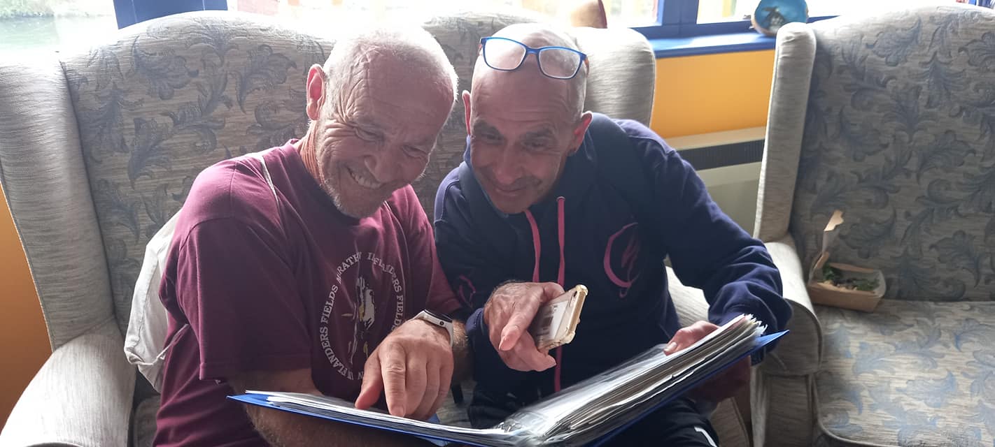 Bushy and pete looking at scrapbook 
